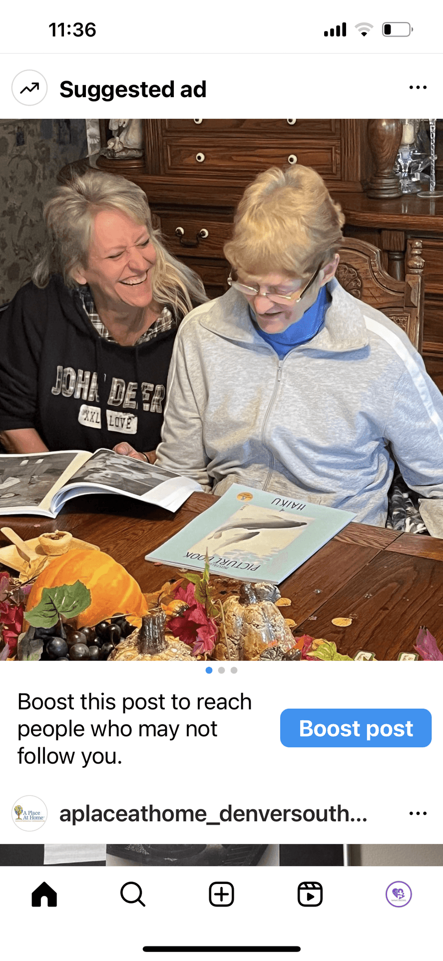 An elderly woman and her niece at a memory cafe enjoy NANA’S BOOKS’ Haiku poetry and smile.